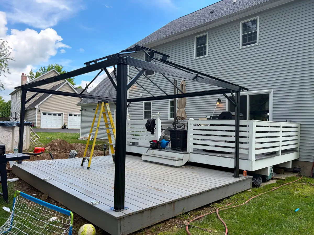Steel frame of a backyard hardtop gazebo during assembly by C&C Multiservices in Connecticut